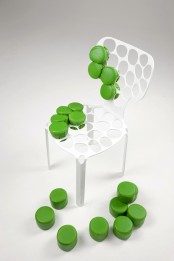 a white metal frame chair with holes and green puff pieces is a cool solution for any modern and bright space, it looks cool and unusual