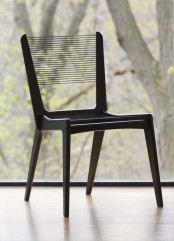 a black chair with a thread back that looks airy and lightweight is a cool idea for a modern space