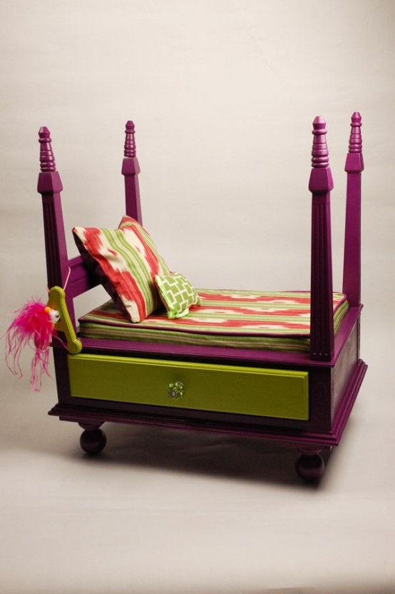 a colorful dog bed on round legs, with a drawer, pillars and colorful bedding is a very chic and bold idea