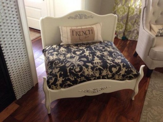 a vintage-inspired white dog bed with a printed mattress and a pillow is a very refined solution to rock