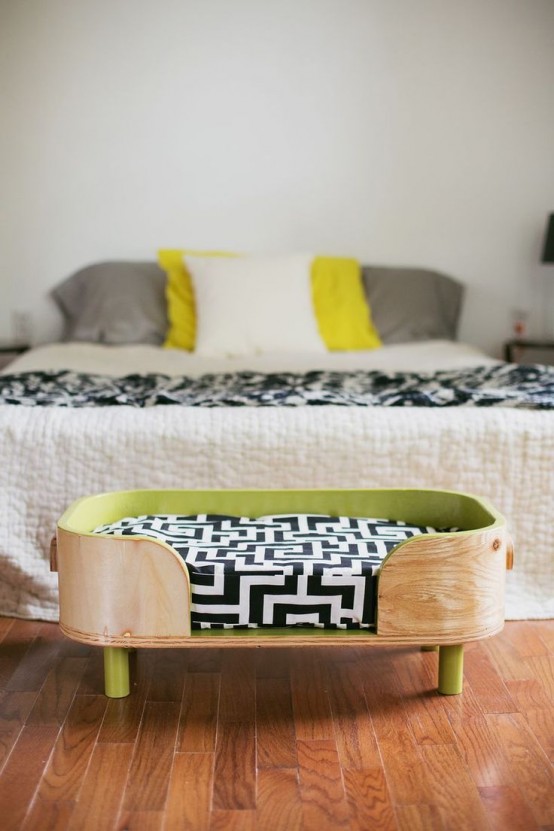 a stylish rounded plywood bed with a green inner and green legs, with a printed cushion is a cool idea for a modern space
