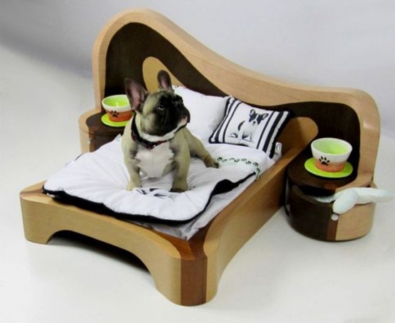 a catchily shaped plywood dog bed with a headboard and additional nightstands with bowls is a fun idea