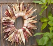 a natural color dired corn husk wreath will be a great decoration for a rustic outdoor space, whether it’s your door or not