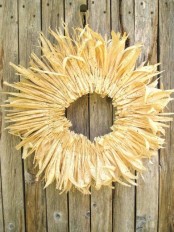 a dired corn husk wreath is a traditional fall decoration that you can eaisl DIY and hang outdoors
