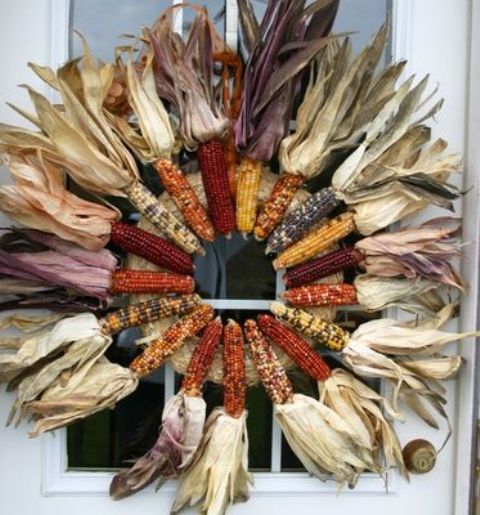 a large and spectacular wreath made of colorful corn cobs with corn husks is a fantastic idea for this fall