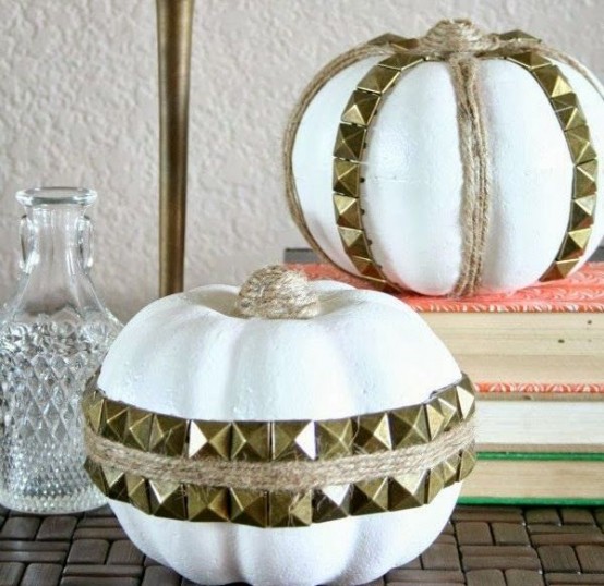 white faux pumpkins with twine and gold spikes attached look fun,, rock and glam and will add an edgy touch to the space