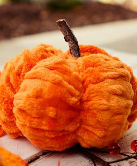 a bright orange faux fur pumpkin with a stem is a gorgeous decoration for the fall