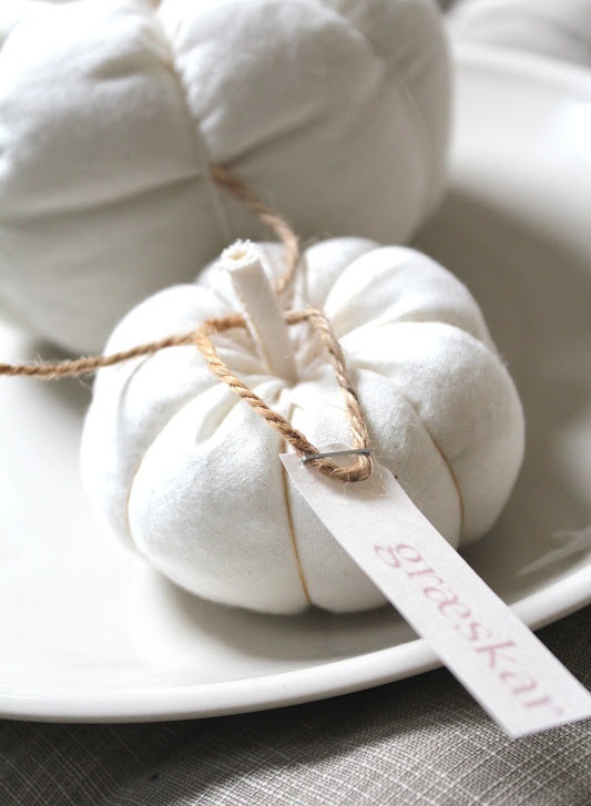 a white fabric pumpkin with twine and a tag can be used as decor, a favor or escort card in the fall