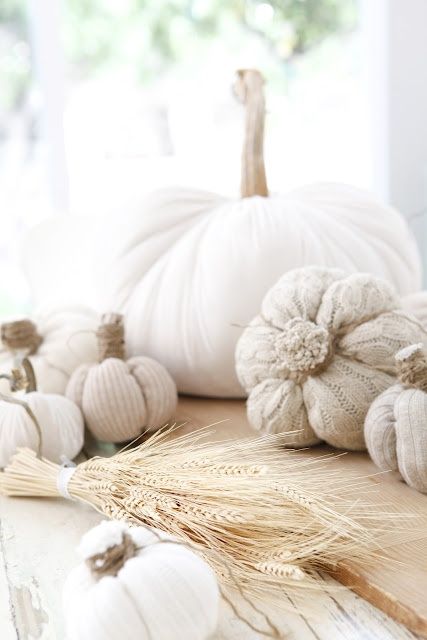 white fabric pumpkins of various fabric including knit and crochet are stylish and ethereal decorations for the fall