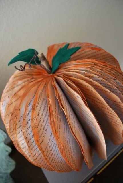 a newspaper pumpkin with orange edges, a stem and green felt leaves is an easy DIY to make and can be made very fast