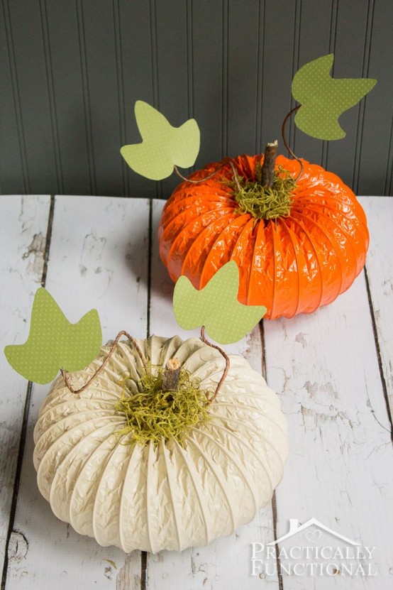 orange and white paper pumpkins with hay, stems and paper leaves are great for decorating for the fall