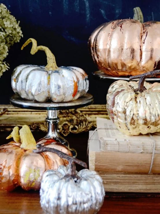 faux pumpkins spruced up with copper, gold and silver leaf are amazing to add a shiny and chic touch to the space