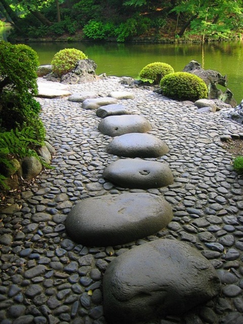smaller stones and larger flattened stones on top fit a zen garden with much greenery