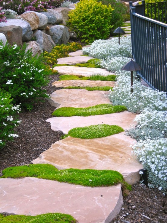 a cool pink stone pathway with green moss growing in between is a chic and bright touch to your outdoor space