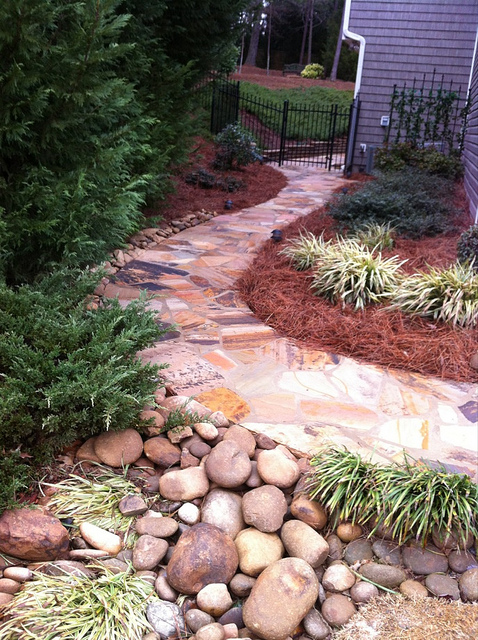 a colorful stone garden path composed as a monolith makes walking on it much more easier and comfortable