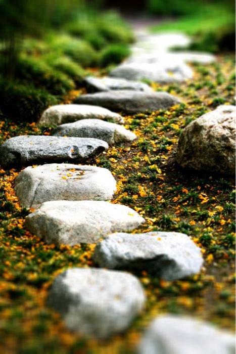 a rough and small stone garden path with sand around is a cool idea with a natural feel though walking on it isn't very comfortable