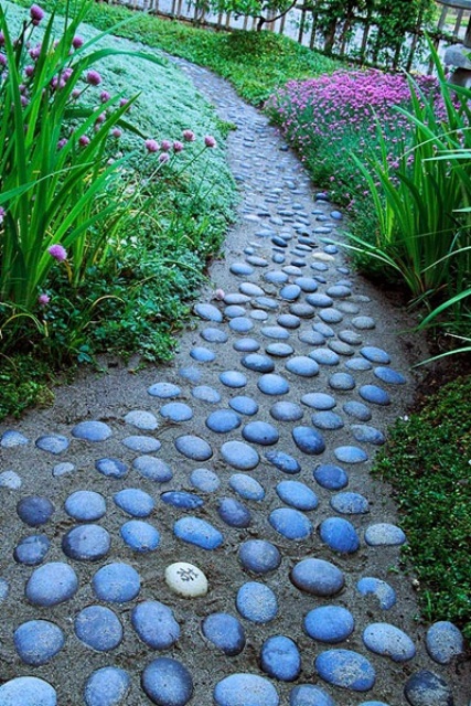 a sand and stone pathway in your garden contrasts the bright blooms, and though it's harder to walk on it, it looks pretty