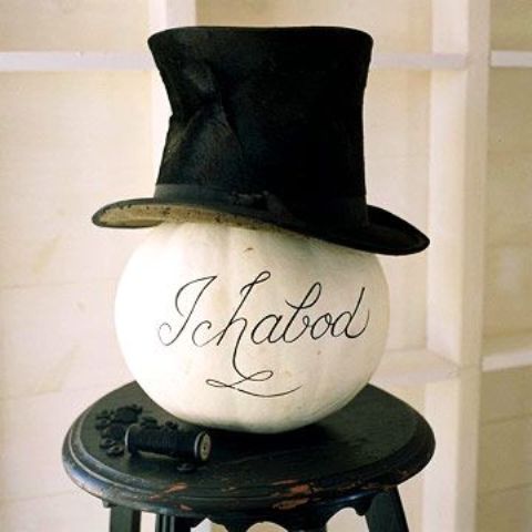 a white pumpkin with calligraphy and a black top hat inspired by the Sleepy Hollow is a creative and cool idea for Halloween