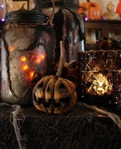 gorgeous vintage Halloween decor with jar luminaries, a rotten pumpkin and a beautiful faceted lantern is a lovely idea