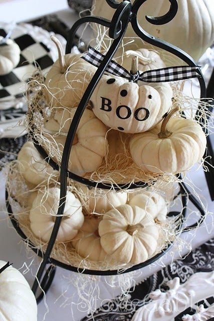 a metal and hay stand with white pumpkins can be isntantly turned into a Halloween one with a single pumpkin decorated with black letters and dots