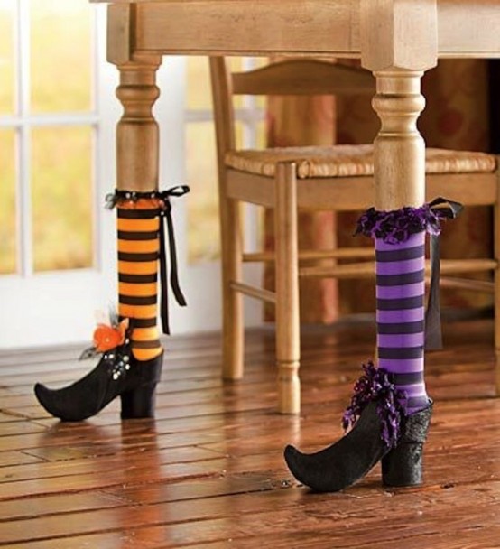 table legs dressed up as witches' legs are a fun and cool idea for a Halloween space, and you may use them not only for a witch-inspired party