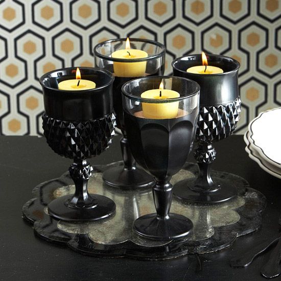 large black goblets used as candleholders are a smart idea for Halloween, they are perfect for decor