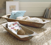 antique dough bowls used for storing pillows, blankets and magazines in a rustic home