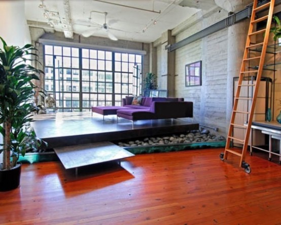 a platform over the pebbles highlights the living room and gives it a zen feel