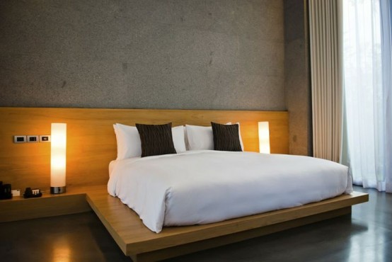 a plywood platform with nightstand shelves and a headboard makes the bedroom more contemporary