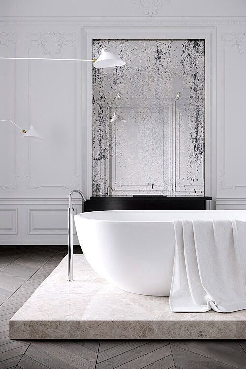 a stone platform makes the sophisticated bathroom even more gorgeous and highlights the bathtub