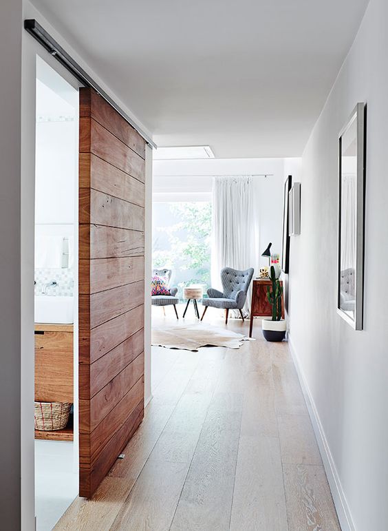 a wooden slab sliding door for a rustic yet contemporary touch