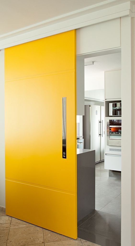 a bright yellow sliding door adds color to the space and makes it cooler