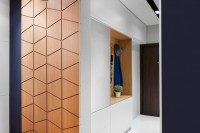 a modern plywood sliding door with a geometric pattern adds chic to the space