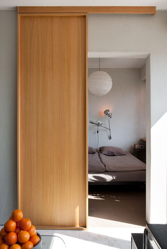 a minimalist plywood sliding door matches the space and makes it cool