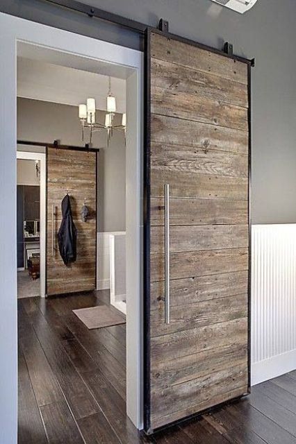 a vintage and rustic sliding door with dark metal framing for a cozy feel