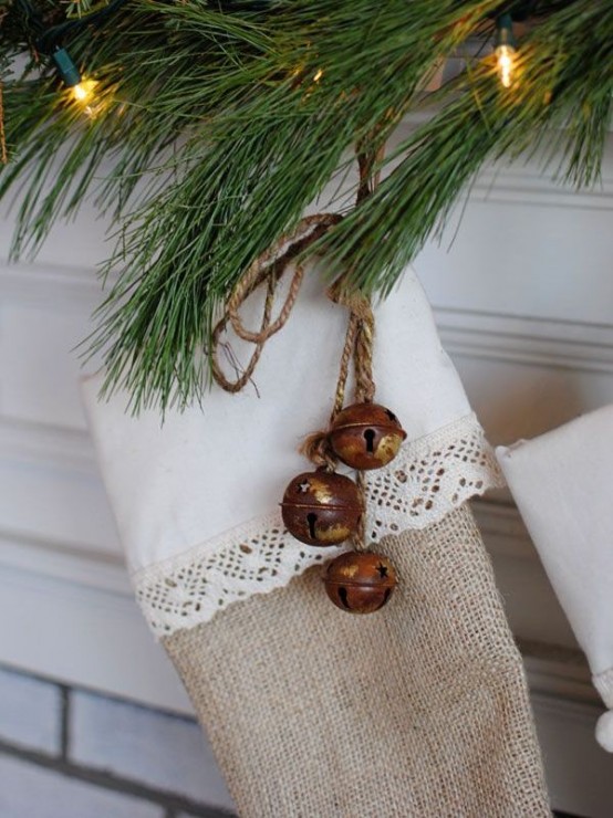 a burlap and lace stocking accented with rusty bells on twine is a very cozy rustic decor idea for Christmas