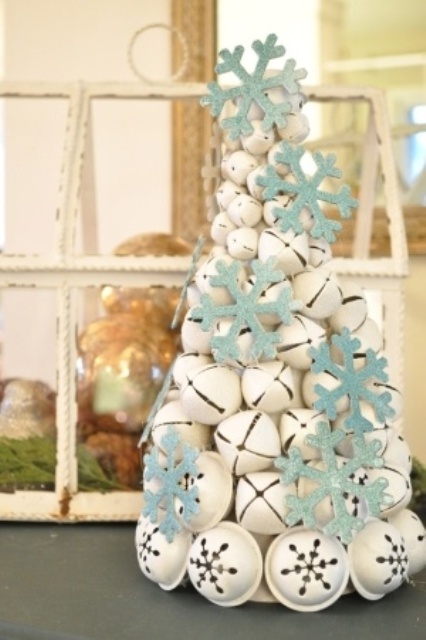a white bell Christmas tree with blue glitter snowflakes is a gorgeous tabletop tree or decoration for any room