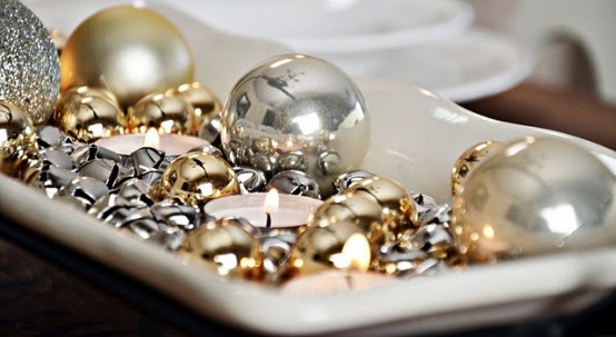 a white tray with silver and gold bells, tealights and silver and gold ornaments is a simple last-minute centerpiece or just decoration to rock