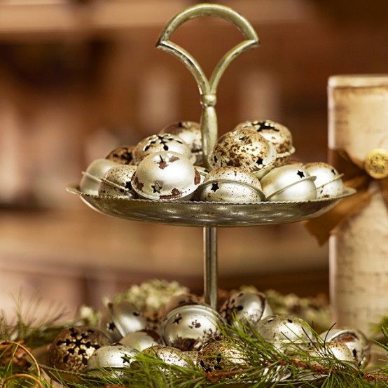 a metallic stand with rusty gold bells and fir branches is a pretty Christmas decoration to make, can be used as a centerpiece, too