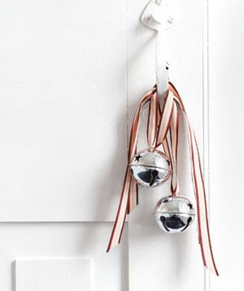 silver bells with striped ribbons can be hung not only a Christmas tree but also on doors