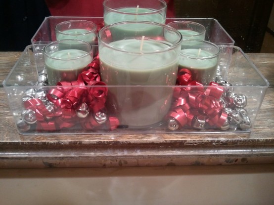 a clear tray with silver bells and green candles in glasses is a cool Christmassy decoration to rock