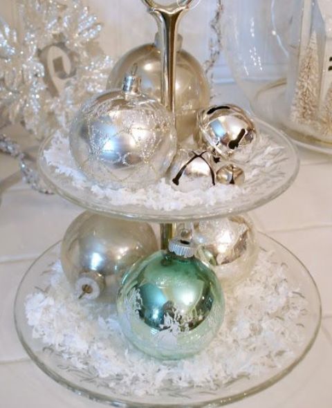a glass stand with faux snow, silver and green ornaments and bells is a pretty and chic decoration in vintage style, make one easily