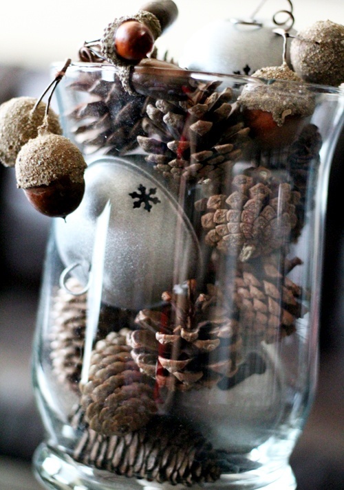 a glass with pinecones, oversized bells and acorns is an easy and cool Christmas centerpiece or just decoration to rock