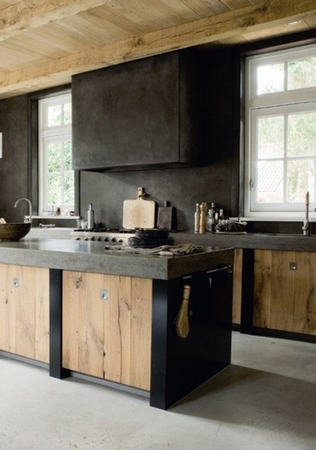 a rough kitchen with a wabi-sabi look, with metal and wood cabinets and a dark metal hood for a contrasting look