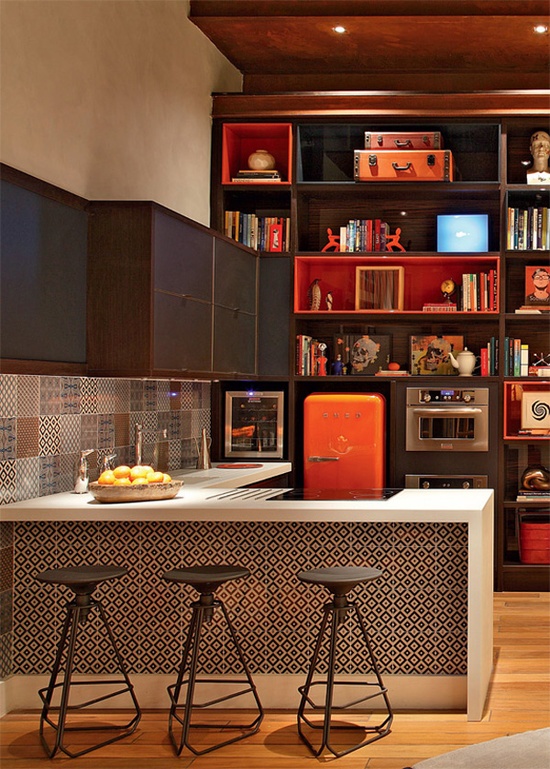 a dark stained wooden kitchen, a white kitchen island with a printed tile backsplash and a catchy backsplash