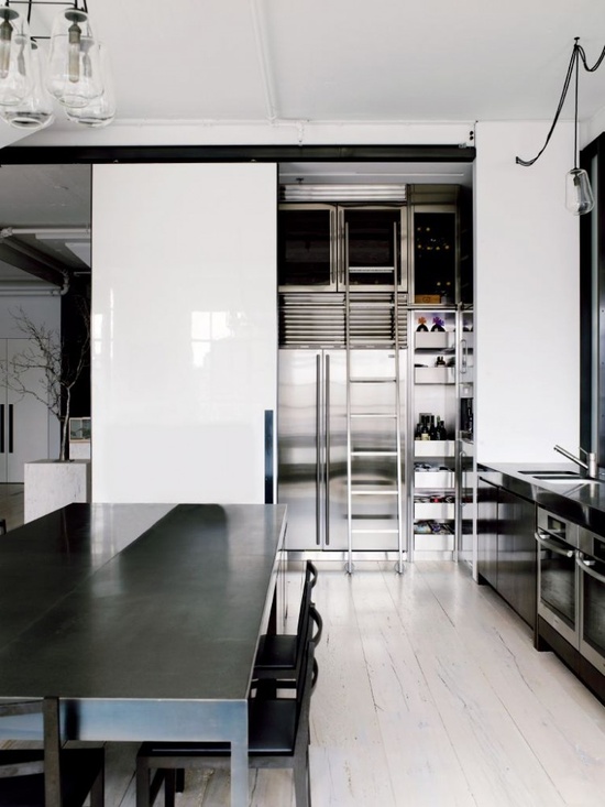 a minimalist black and white kitchen with industrial touches is a chic and very masculine idea with much natural light