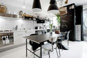 a monochromatic Scandinavian kitchen with white tiles, black furniture and touches of wood and rattan