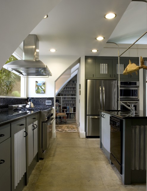 a dark green kitchen with sleek cabinets, white corrugated steel touches and built-in lights