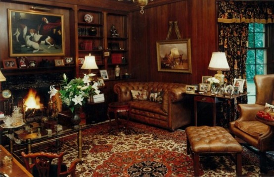 a vintage-inspired living room with leather furniture, glass tables, artworks and a fireplace for maximal coziness