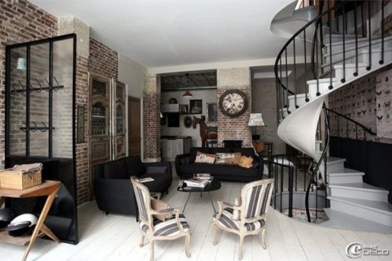a gorgeous living room with brick walls, dark upholstered furniture, wooden coffee tables and a vintage clock